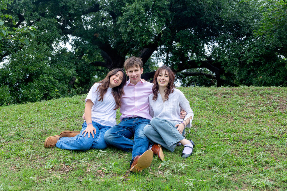 three siblings in family photo at the park in austin, texas