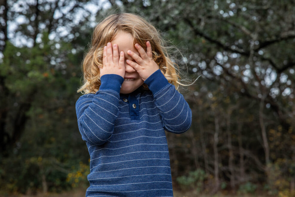 toddler playing peekaboo at austin family photo session