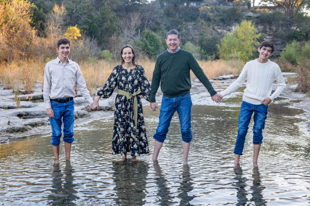 family photo session in water at bull creek park in austin, texas