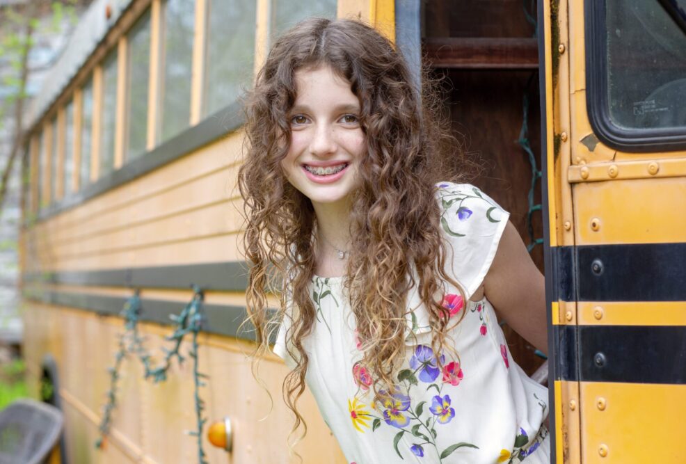 middle school girl on school bus at Sekrit Theater